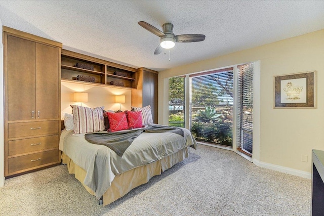 bedroom with light colored carpet, a textured ceiling, and access to outside