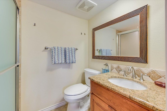 full bathroom with vanity, baseboards, visible vents, a shower stall, and toilet