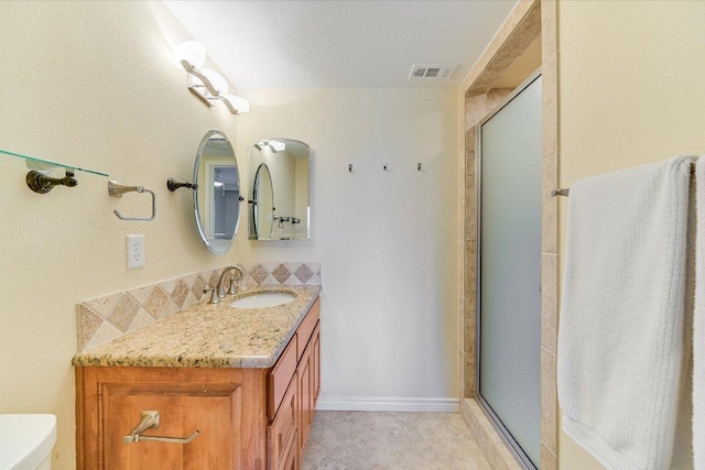 full bath featuring visible vents, toilet, a stall shower, baseboards, and vanity