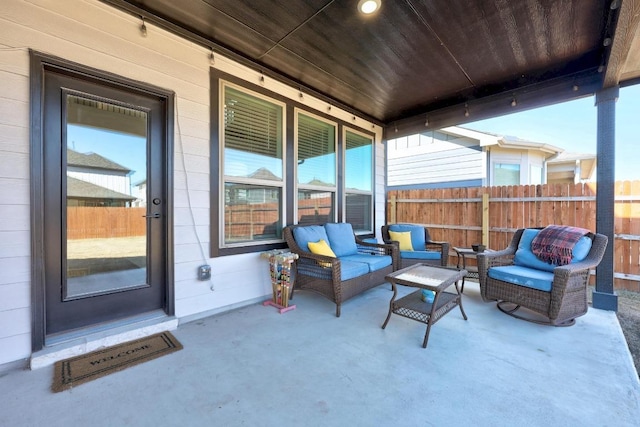 view of patio / terrace featuring an outdoor hangout area and fence