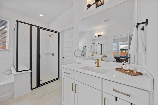 bathroom with visible vents, vanity, connected bathroom, and a shower stall