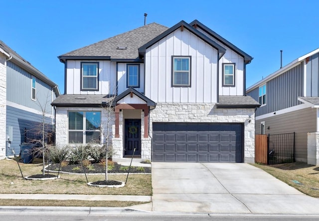 modern farmhouse with board and batten siding, a shingled roof, concrete driveway, stone siding, and an attached garage