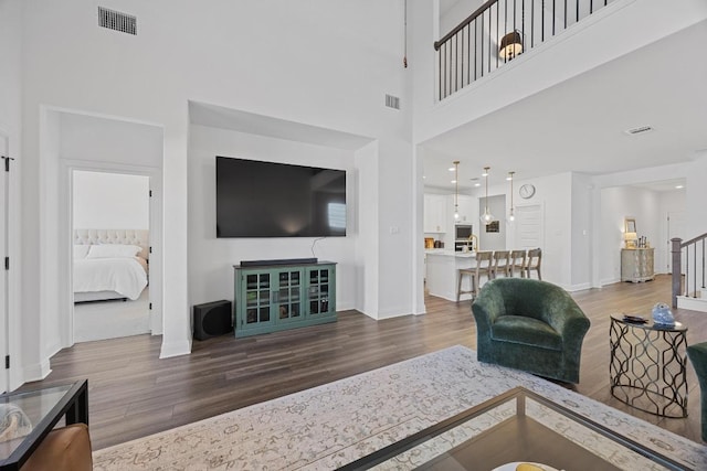 living room featuring visible vents and wood finished floors