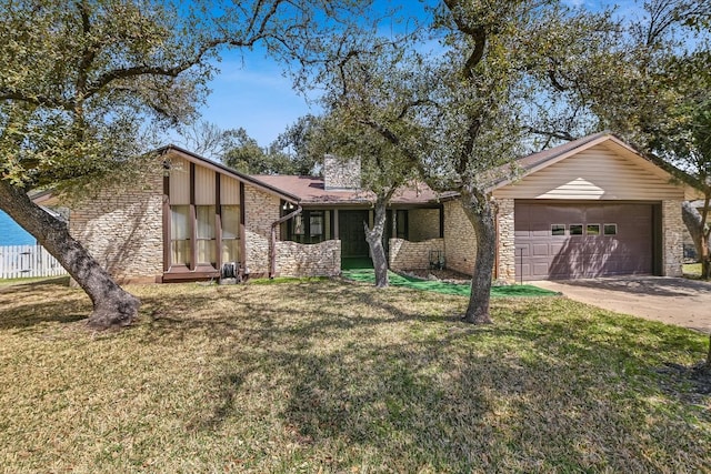 mid-century modern home featuring stone siding, fence, concrete driveway, an attached garage, and a front yard