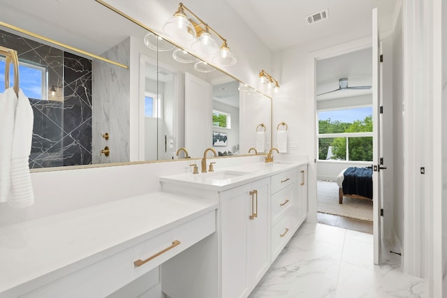 full bath featuring a sink, a marble finish shower, marble finish floor, and double vanity