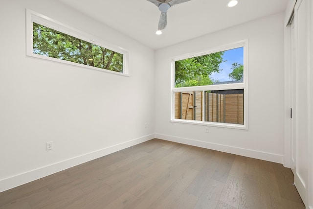 unfurnished room featuring recessed lighting, baseboards, wood finished floors, and a ceiling fan