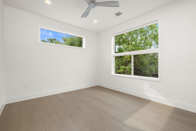 unfurnished room featuring visible vents, recessed lighting, baseboards, and wood finished floors