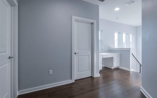 empty room featuring visible vents, recessed lighting, baseboards, and dark wood-style flooring