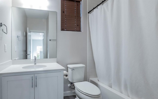 bathroom featuring vanity, shower / tub combo, and toilet