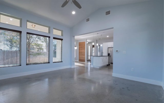 unfurnished living room featuring a sink, visible vents, baseboards, and a ceiling fan