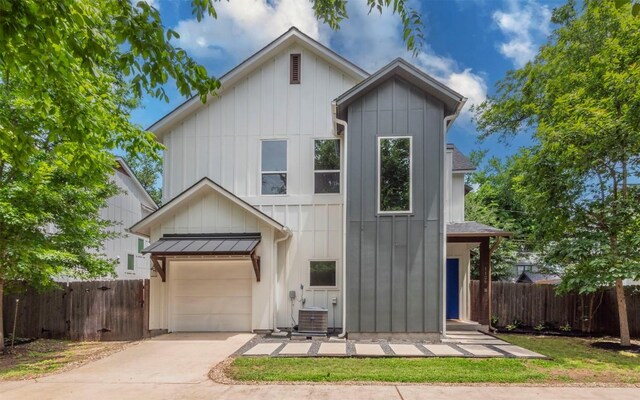 1128 Gunter St Unit B, Austin, TX 78702 - view of front of home with board and batten siding, concrete driveway, central AC, and a garage