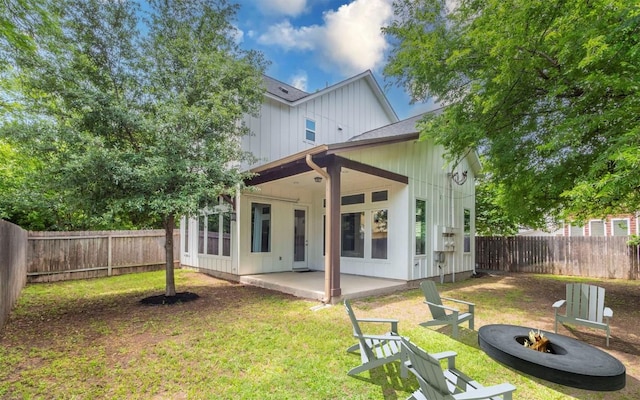 1128 Gunter St Unit B, Austin, TX 78702 - rear view of house with an outdoor fire pit, board and batten siding, and a patio