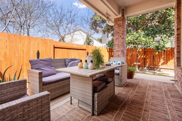 view of patio featuring outdoor dining area and a fenced backyard