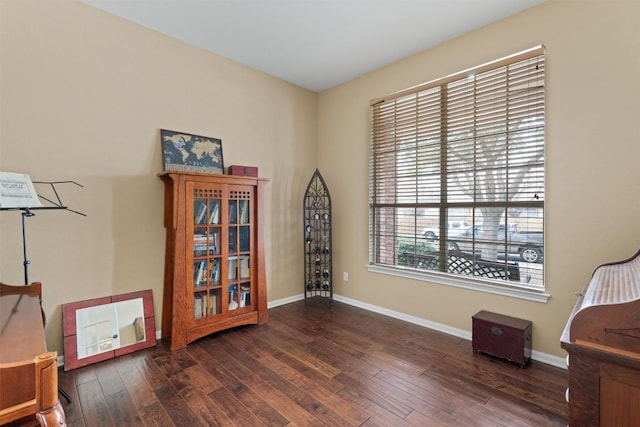 sitting room featuring baseboards and hardwood / wood-style flooring