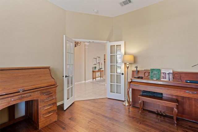 office area with visible vents, french doors, and wood finished floors