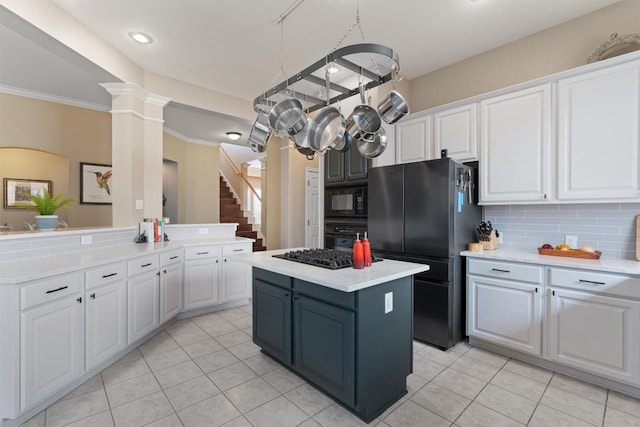 kitchen featuring a center island, decorative backsplash, white cabinets, and black appliances