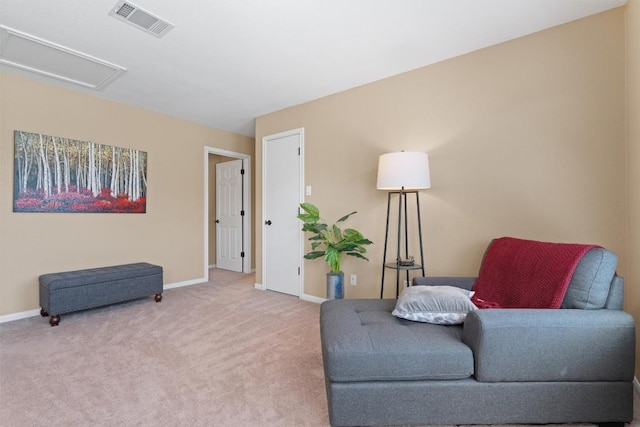 sitting room with visible vents, carpet flooring, attic access, and baseboards