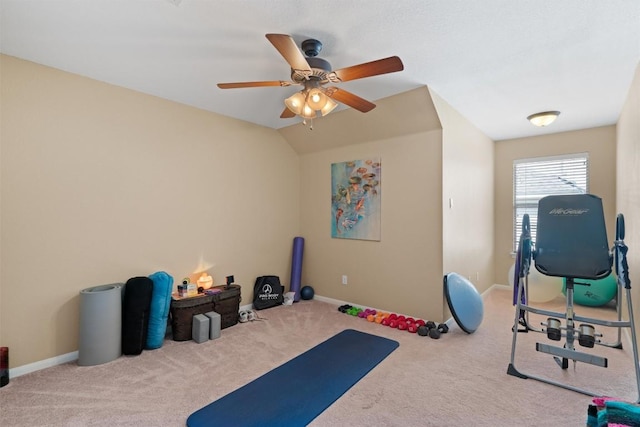 workout area featuring ceiling fan, baseboards, carpet, and vaulted ceiling