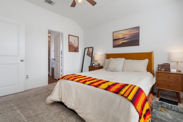 carpeted bedroom with ensuite bath, lofted ceiling, a ceiling fan, and visible vents