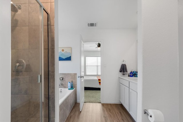 bathroom with visible vents, a stall shower, ensuite bathroom, and a garden tub