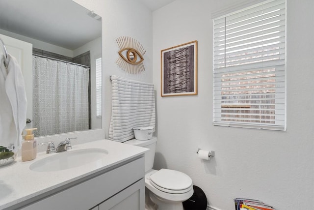 full bath with vanity, curtained shower, and toilet