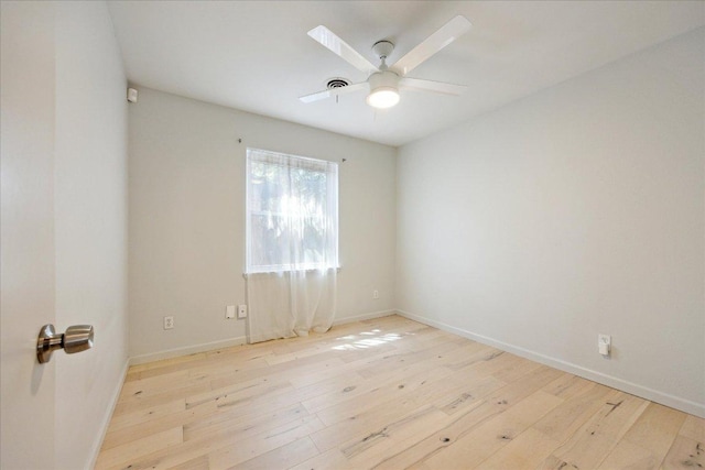 empty room with baseboards, ceiling fan, and hardwood / wood-style flooring