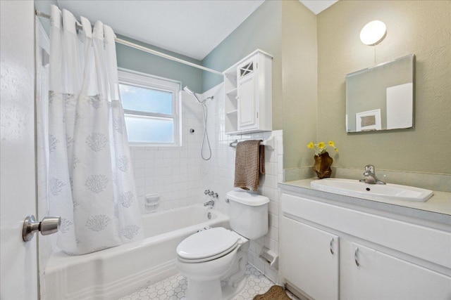 full bathroom with vanity, toilet, shower / bath combo with shower curtain, and tile patterned flooring