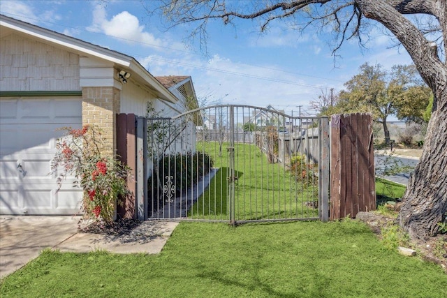 view of gate featuring a yard and fence