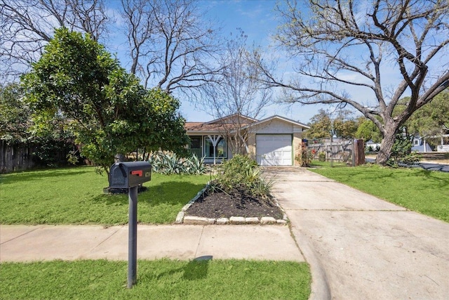 view of front of property featuring a garage, driveway, a front lawn, and fence