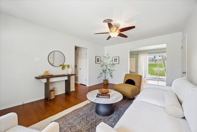 living room with baseboards, a ceiling fan, and wood finished floors