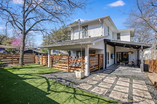 rear view of house with a patio area, a yard, ceiling fan, and fence