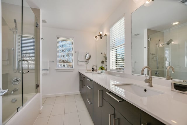 full bathroom with tile patterned flooring, double vanity, baseboards, and a sink