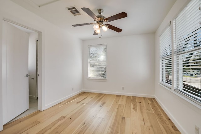 unfurnished room featuring visible vents, ceiling fan, baseboards, and light wood-style floors