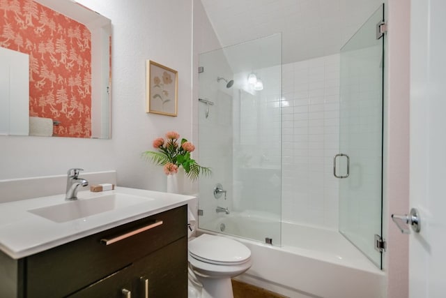 bathroom with enclosed tub / shower combo, toilet, and vanity