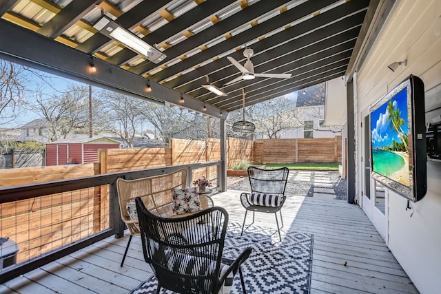 wooden deck featuring a fenced backyard and a ceiling fan