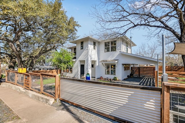 view of front of property with a fenced front yard, board and batten siding, and a gate