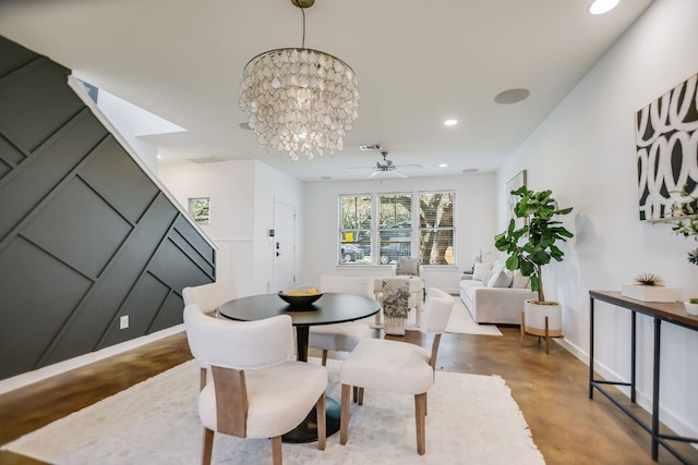 dining room featuring ceiling fan with notable chandelier, recessed lighting, visible vents, and concrete flooring