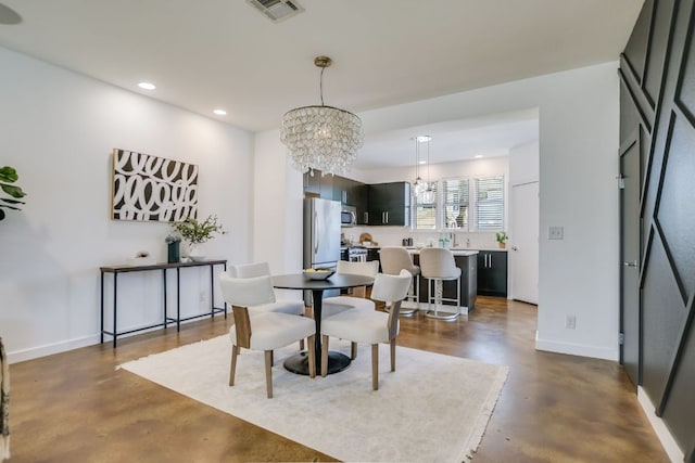 dining area with visible vents, finished concrete flooring, baseboards, recessed lighting, and a notable chandelier