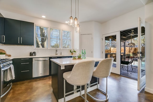 kitchen with backsplash, a center island, concrete floors, light countertops, and stainless steel appliances