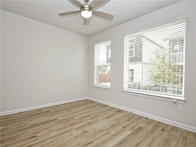 empty room with light wood-style flooring, baseboards, and ceiling fan