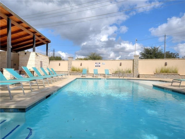 pool featuring a patio and fence