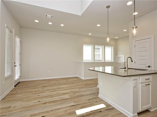 kitchen with visible vents, light wood-style flooring, a sink, recessed lighting, and white cabinets