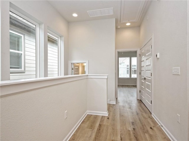 hallway with visible vents, recessed lighting, light wood-style floors, baseboards, and attic access