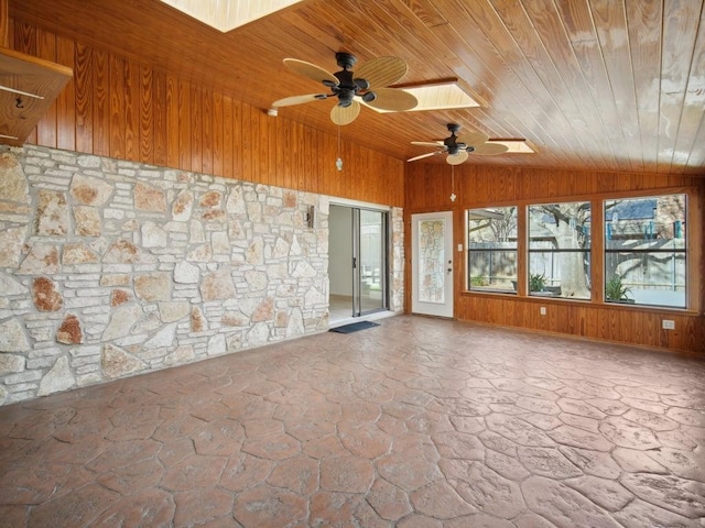 unfurnished sunroom featuring vaulted ceiling, wood ceiling, and ceiling fan