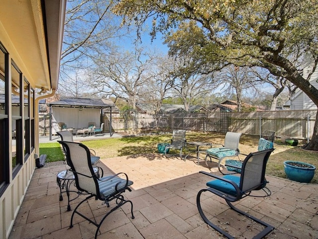 view of patio with an outbuilding and a fenced backyard