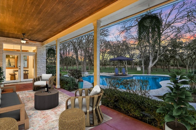 exterior space featuring a ceiling fan, french doors, and an outdoor pool