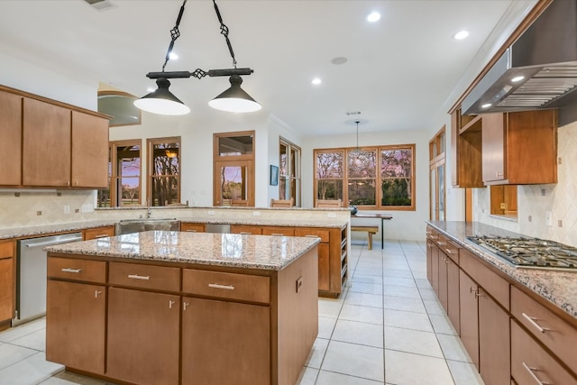 kitchen with backsplash, a center island, stainless steel appliances, a peninsula, and extractor fan