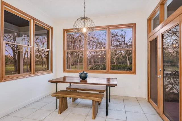 dining room featuring light tile patterned floors and baseboards