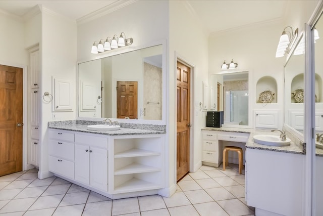 full bathroom with a sink, two vanities, ornamental molding, and tile patterned floors