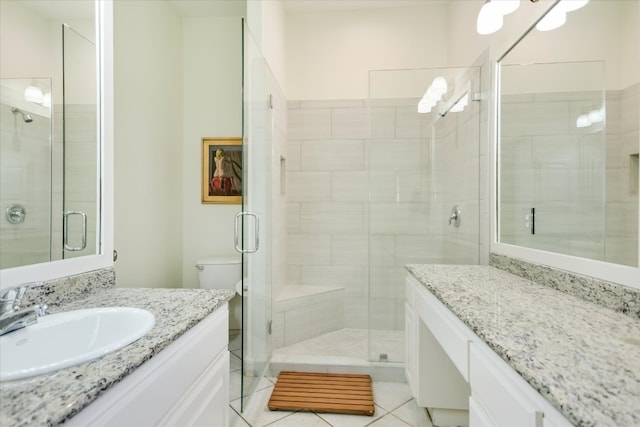 full bathroom featuring tile patterned flooring, a shower stall, and vanity